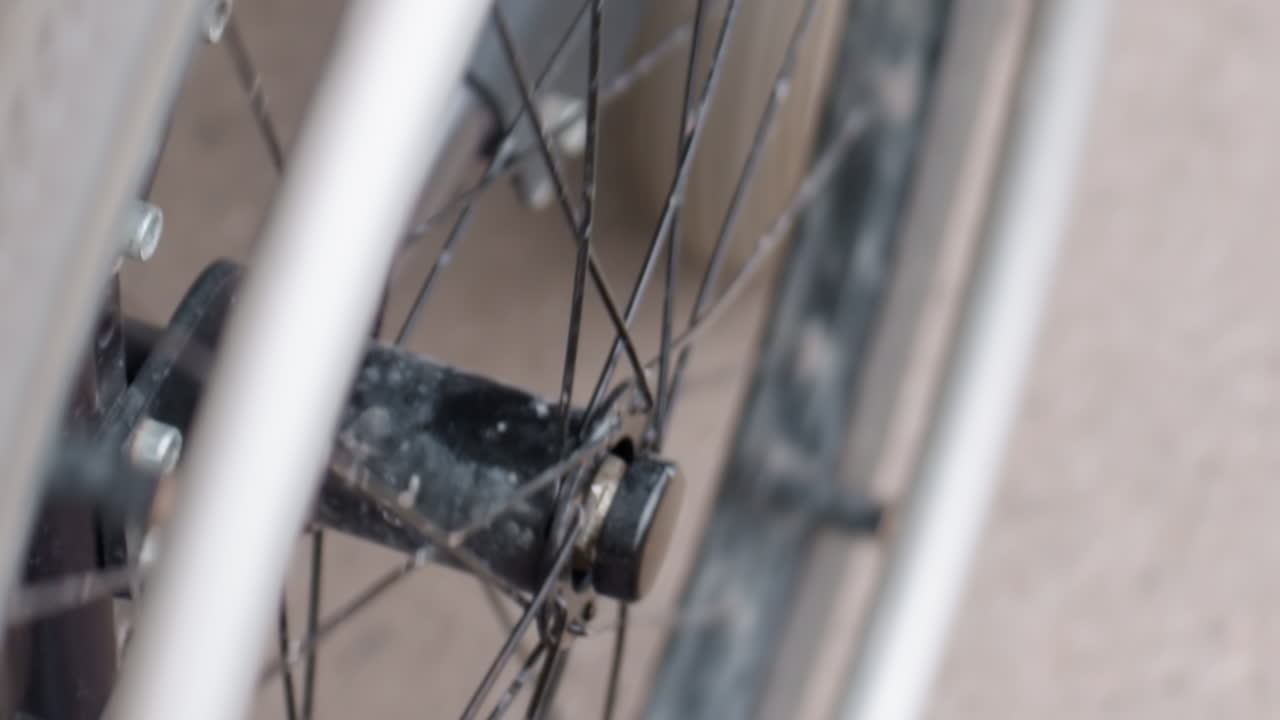 Wheelchair Wheel Rim White Tire Closeup, Intimate LowAngle Capture Showing Handrim, Spokes And Frame, Motion Suggestion On Urban Pavement, Emphasis On Ergonomic Design And Active Mobility, Optimistic