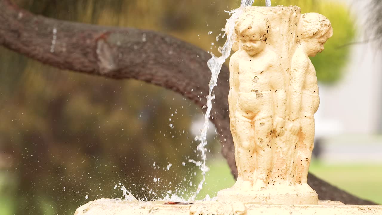 A detailed view of a fountain statue with water splashing, captured in natural light at Great Ocean Road, Australia