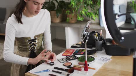 caucasian non-binary transgender woman doing make up