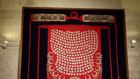 intricate silver tribal necklace on display