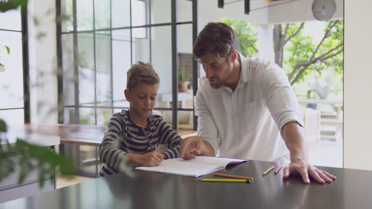 padre ayudando a su hijo en la tarea en casa 4k