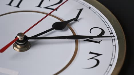 old retro wall clock with moving second hand on white circular dial