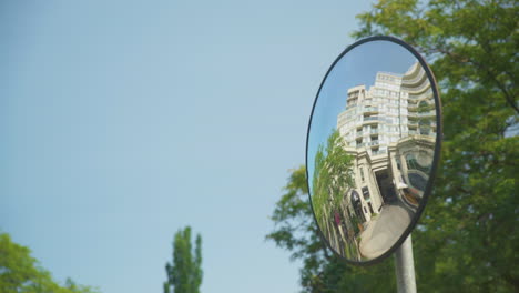 a rounded traffic safety mirror with a garage being reflected