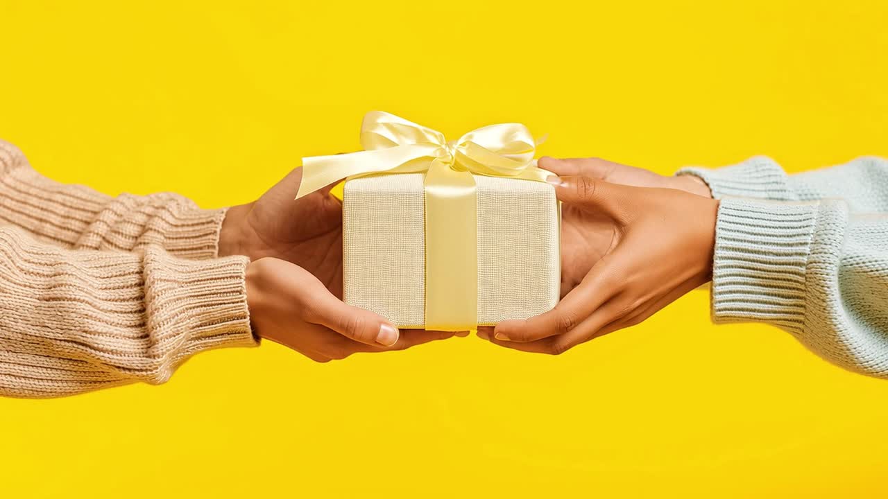 Hands offering a gift on yellow background