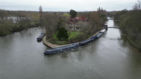 narrow boats moored river thames d'oyly carte island weybridge surrey drone aerial view