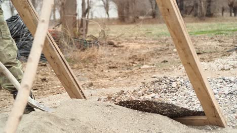 shovel, heap of sand and sieve in action