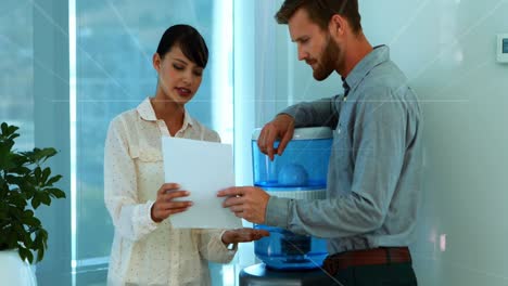 Grid-lines-over-cauasian-male-and-female-colleagues-in-a-office