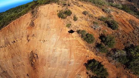 Aerial-View-of-Helicopter-Shadow-over-Rolling-Hills-and-Green-Landscape-in-Kauai-Hawaii