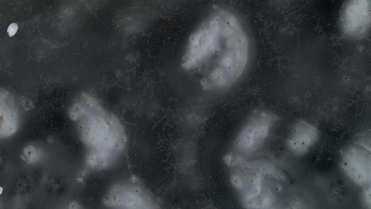 Aerial view of ice. Patterns of snow on a frozen lake on a winter cloudy afternoon