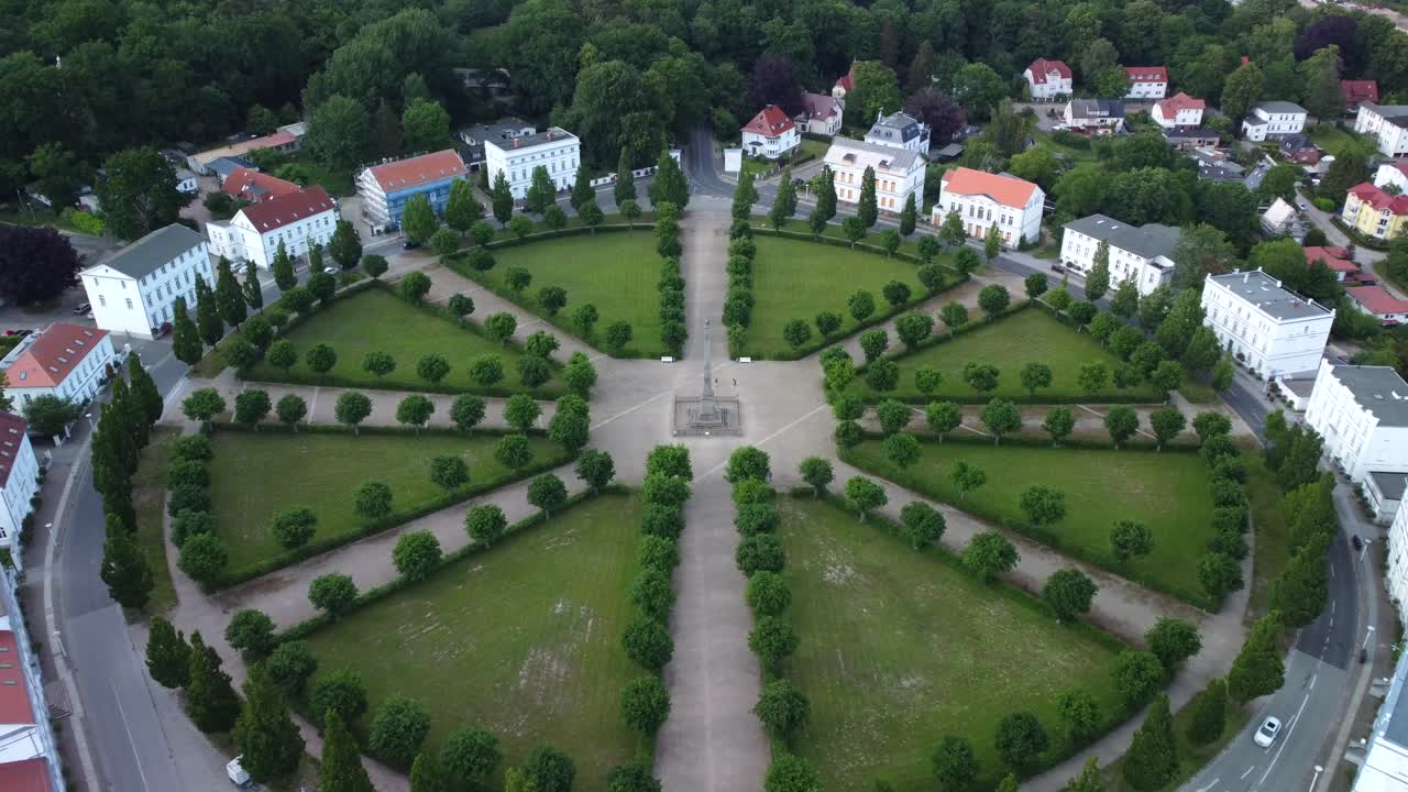 Incoming drone shot of the historical classic circus square of Putbus Town with white houses, located on the R&uuml;gen Island in Germany