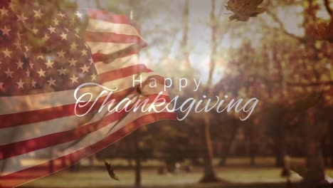 animation of happy thanksgiving, flag of usa and falling leaves over autumn park