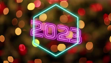 Animation-of-2022-text-and-neon-shapes-over-christmas-tree