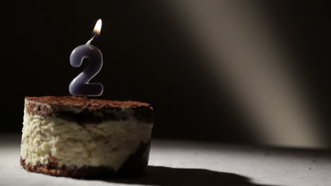 candle two in tiramisu cake