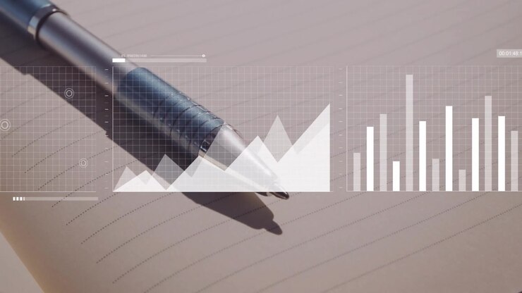 Metalpen hviler på en linjeret notesbogside, der viser et gennemsigtigt datagitter med område- og søjlediagrammer.