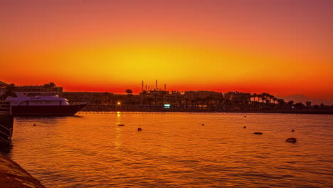 tropical town with lights and moored yachts during sunset, fusion time lapse