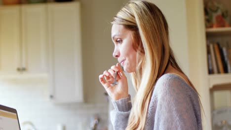 woman using laptop while having breakfast 4k