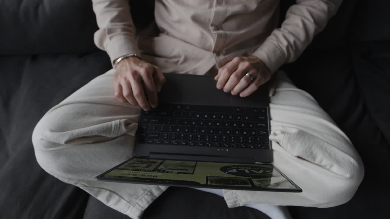 A person sitting and using a laptop
