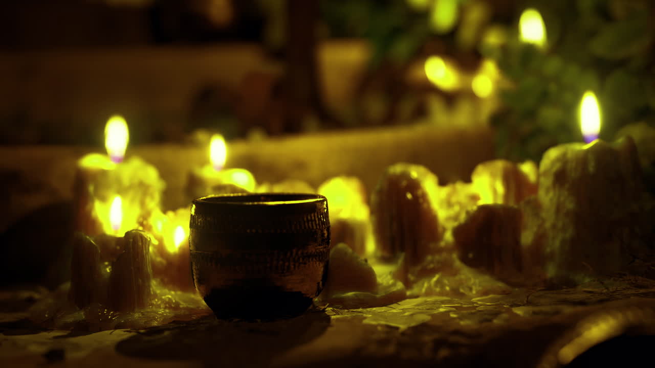 Soft candlelight illuminates a tranquil setting with natural elements