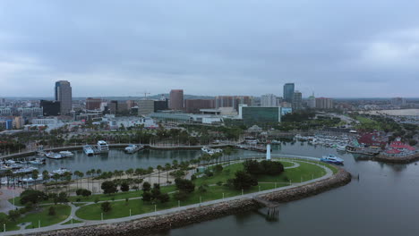 aerial view of the coastline walking path and rainbow harbor marina with the long beach, california skyline in the background