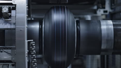 Automated tyre production technology view at modern industrial factory closeup