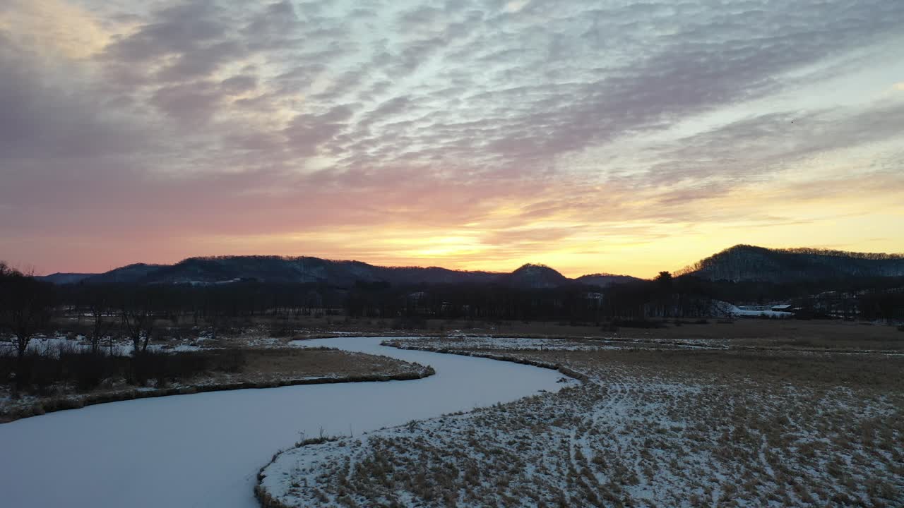 Winter Sunrise over Frozen Creek and Mountains
