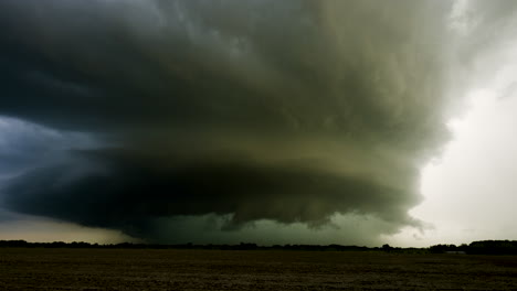 spinning storm approaches across open farmland time lapse