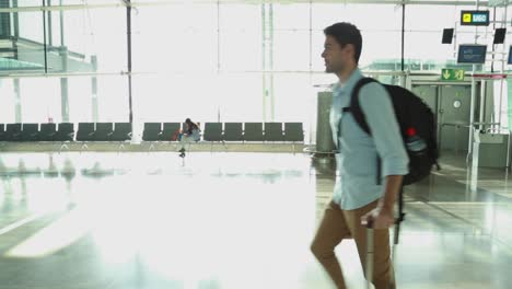 male traveler passing by through the gates area, in an empty airport