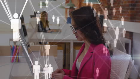 network of connections animation over businesswoman working on laptop in office