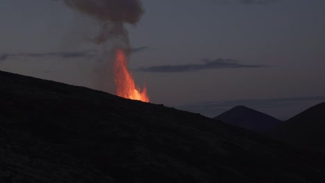 lava erupting over mountain ridge iceland