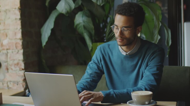 Businessman Working on Laptop in Coffeeshop