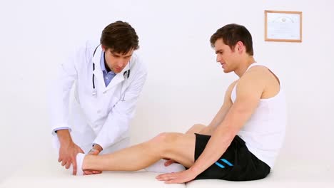 doctor checking patients injured ankle