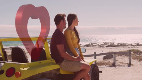 couple sitting on yellow beach buggy by ocean with heart animation overlay