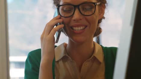 Female-business-executive-talking-on-mobile-phone