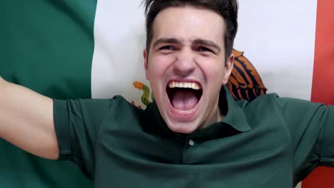 mexican young man celebrates holding the flag of mexico in slow motion