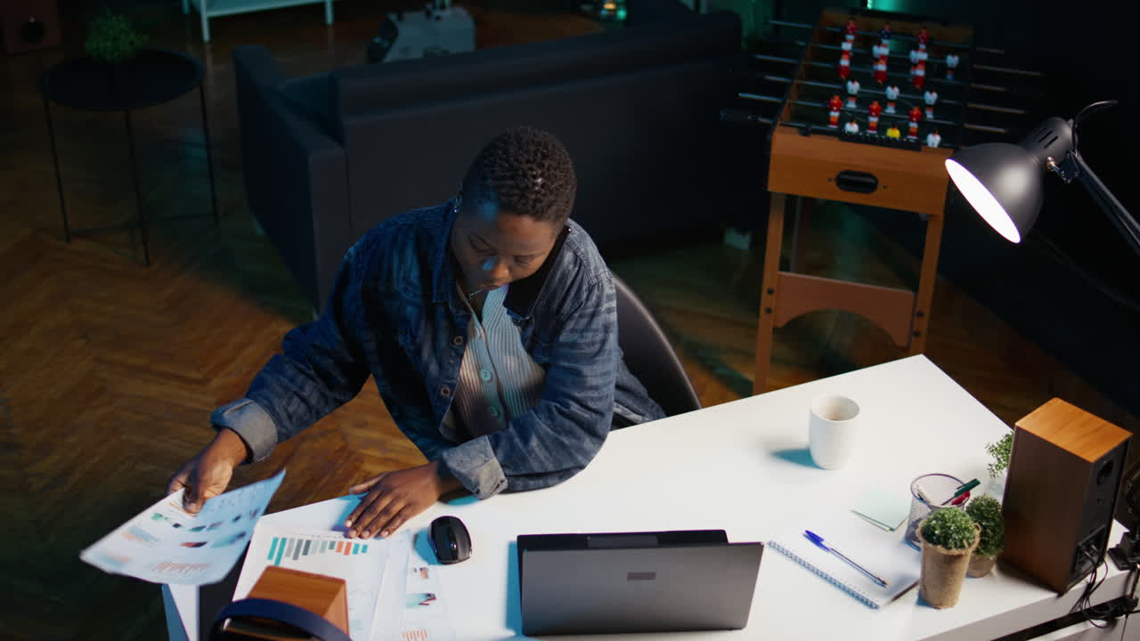Woman working late at home office