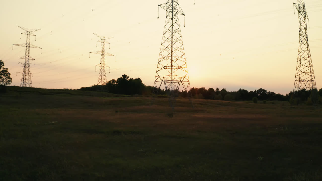 High Voltage Electric Transmission Power Lines Silhouette in Rural Countryside Field
