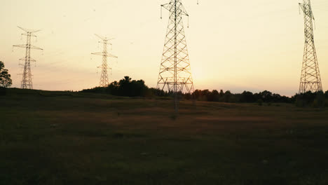 High-Voltage-Electric-Transmission-Power-Lines-Silhouette-in-Rural-Countryside-Field