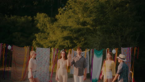 friends walking towards couple standing at beach