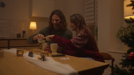 couple enjoying a warm drink together during the holidays