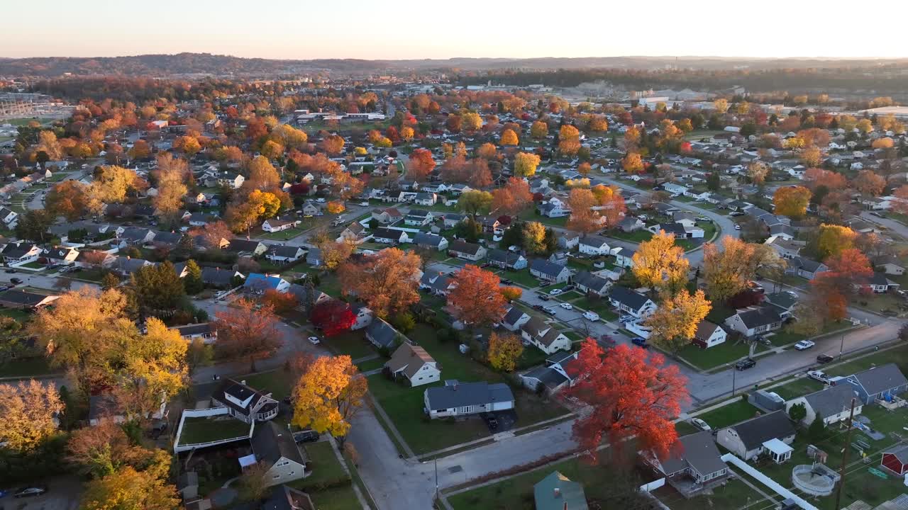 vista aérea de una zona suburbana con árboles de colores de otoño al atardecer
