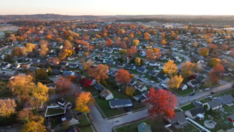 aerial view of a suburban area with autumn-colored trees at sunset