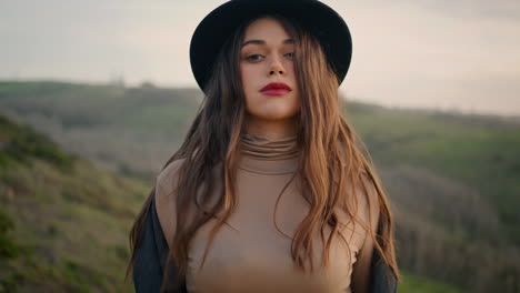 lonely woman walking rural road in elegant hat closeup. girl enjoying autumn.