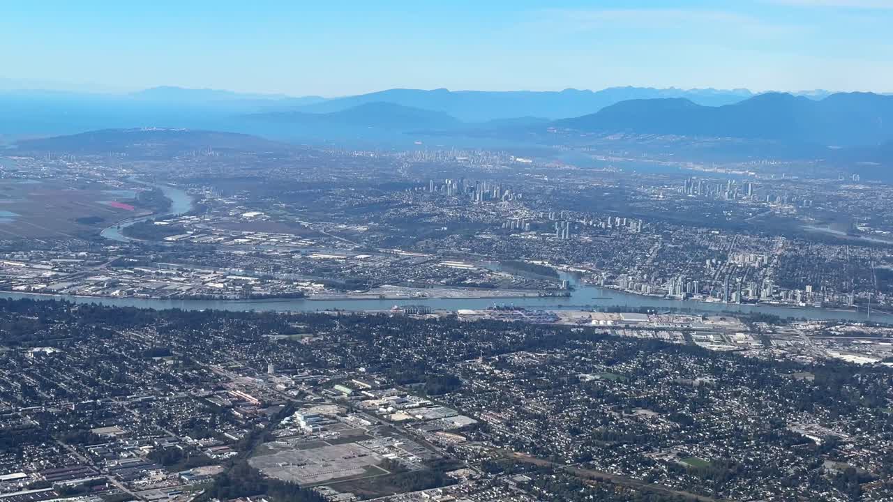 Airplane window POV shot of Greater Vancouver, British Columbia, Canada. 4K
