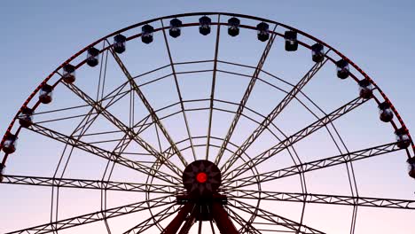 large ferris wheel with illumination, against the sky, sunset, twilight