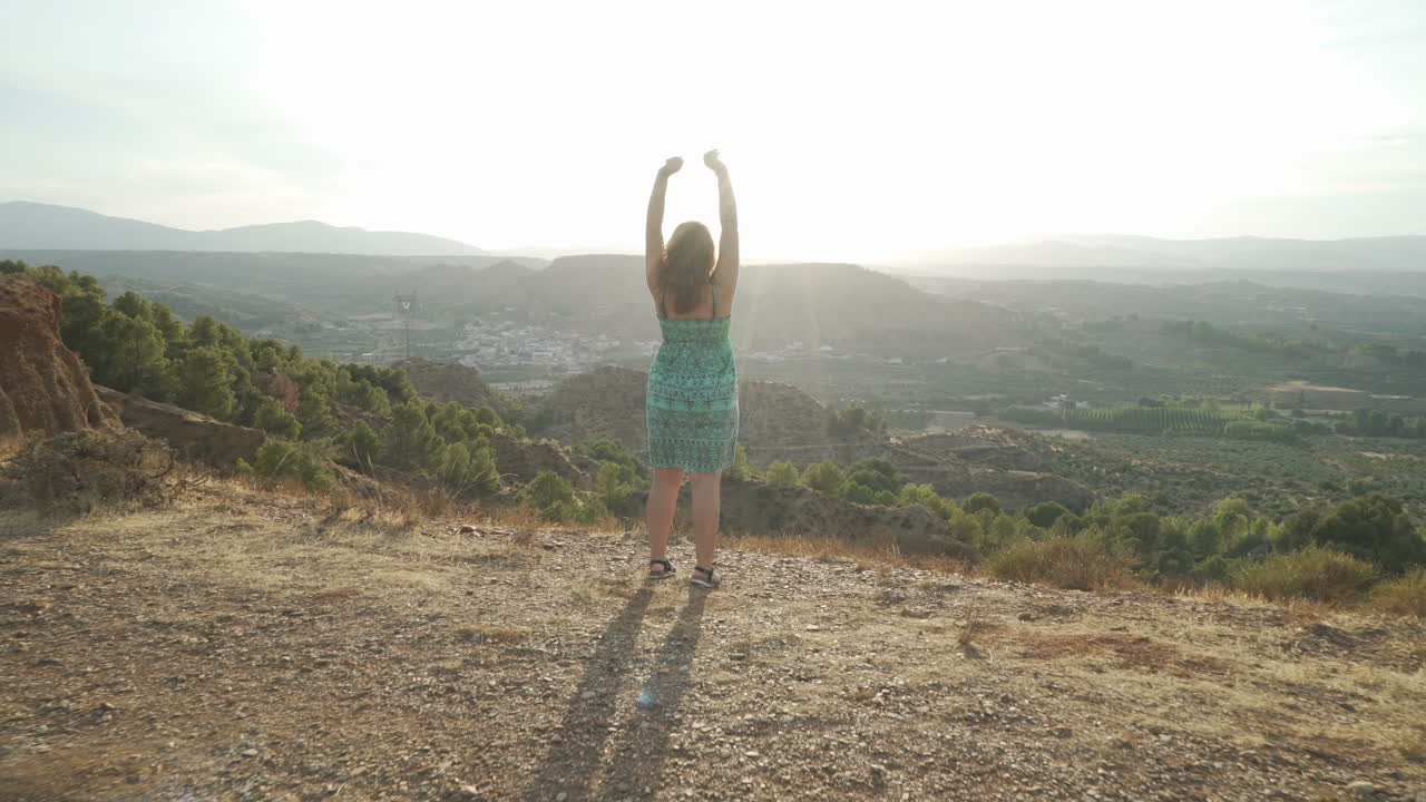 Woman Celebrating Success in a Beautiful Landscape