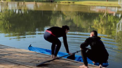 people preparing to kayak on a lake