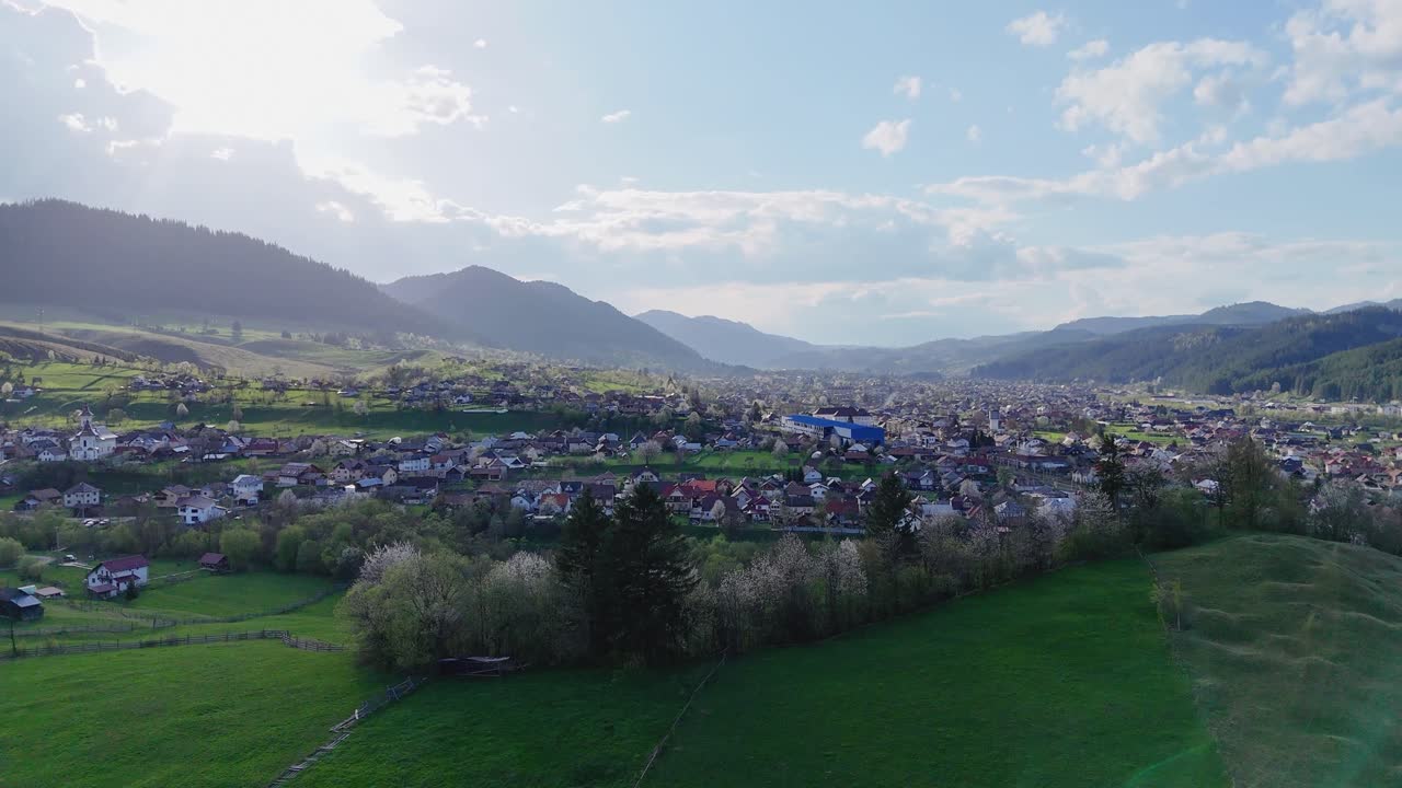 Drone pull back of Campulung showing nature and houses
