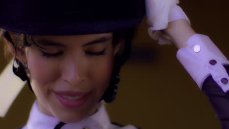 Happy-Young-Jockey-Girl-Snaps-Helmet-Straps-Underneath-Her-Chin-and-Set-Right-Hat-Getting-Ready-for-a-Horse-Riding---face-close-up