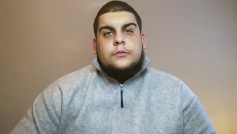 young university student listening intently whilst looking directly into camera