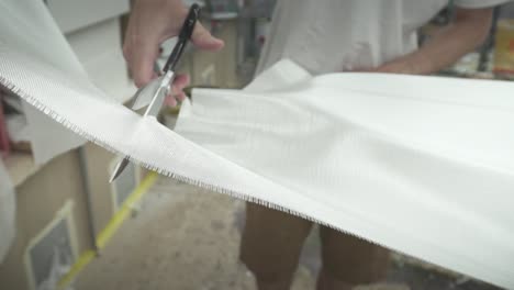 surfboard being made cutting fibre glass